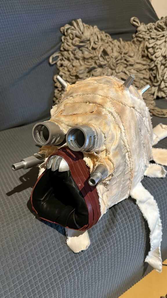 Weathered costume mask in progress on a work surface
