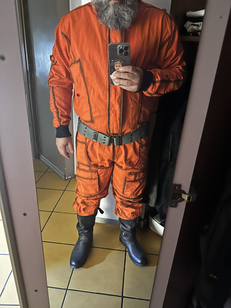 Orange pilot costume worn for a mirror fitting photo