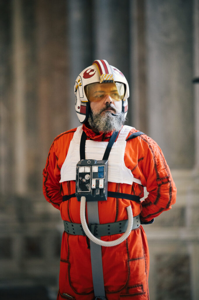 Orange pilot costume with helmet and chest equipment outdoors
