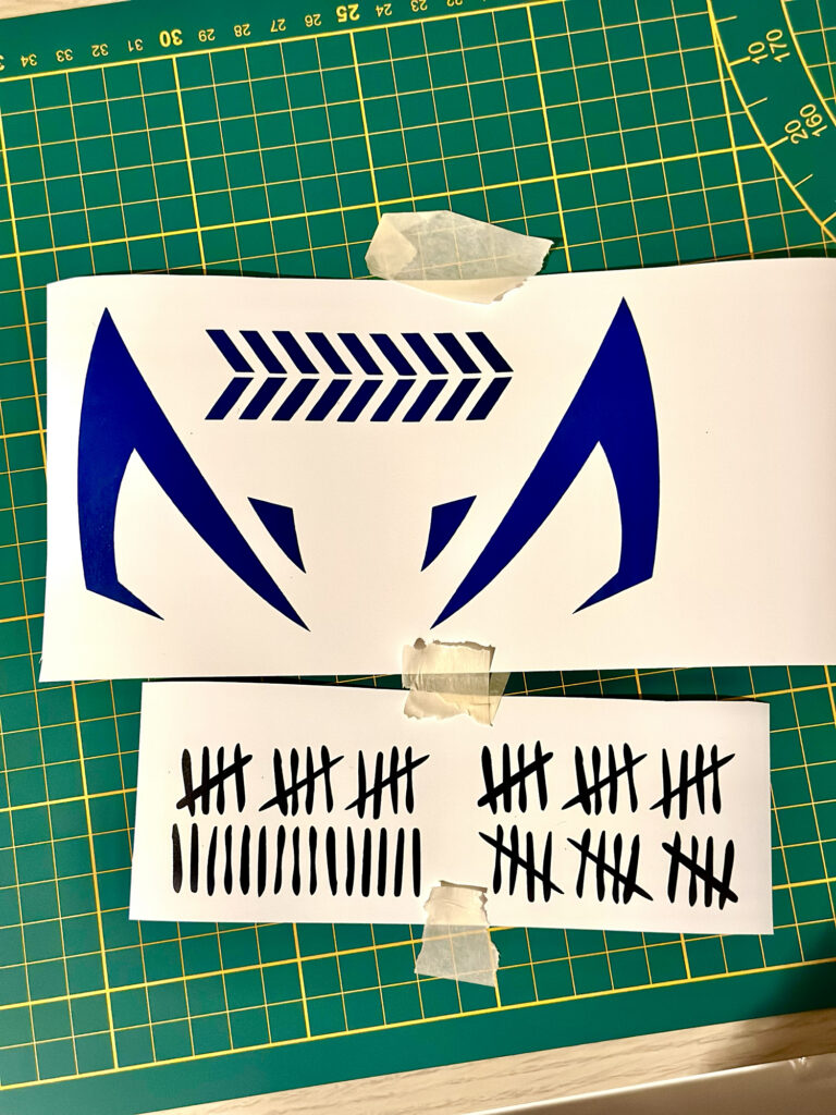 Blue geometric decal and tally mark stickers being prepared