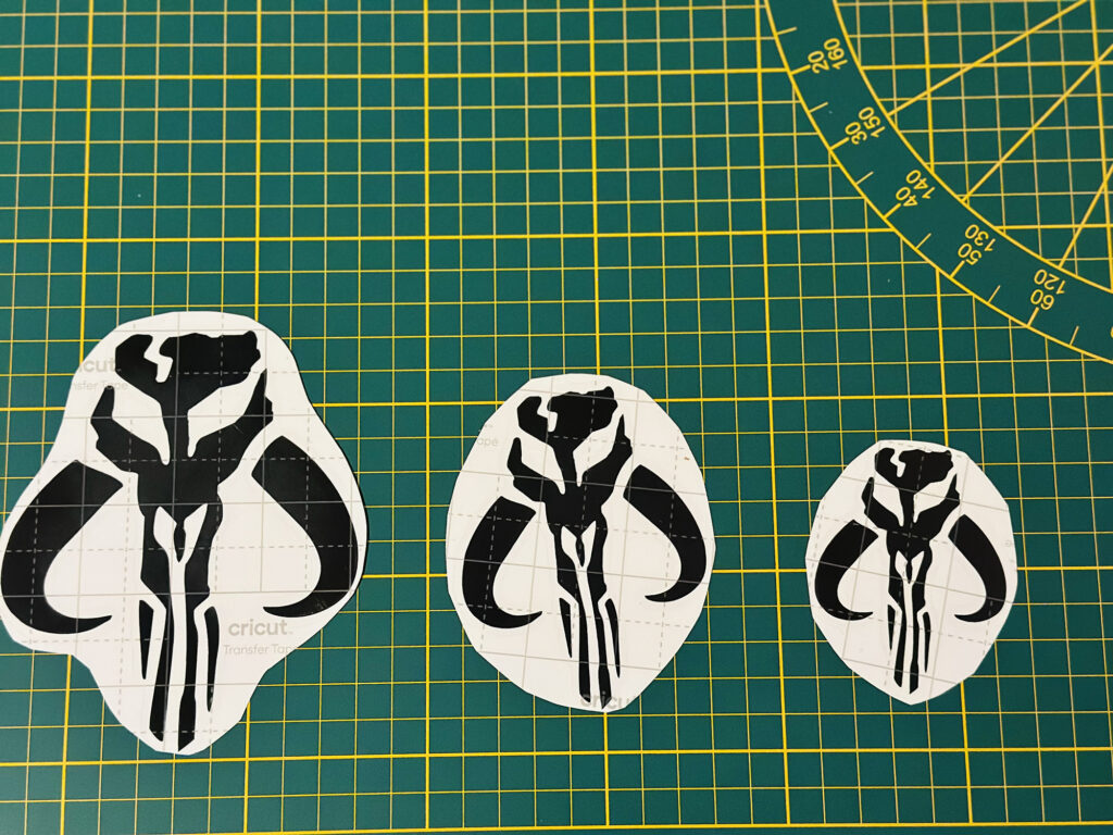 Black skull emblem stickers on a green cutting mat