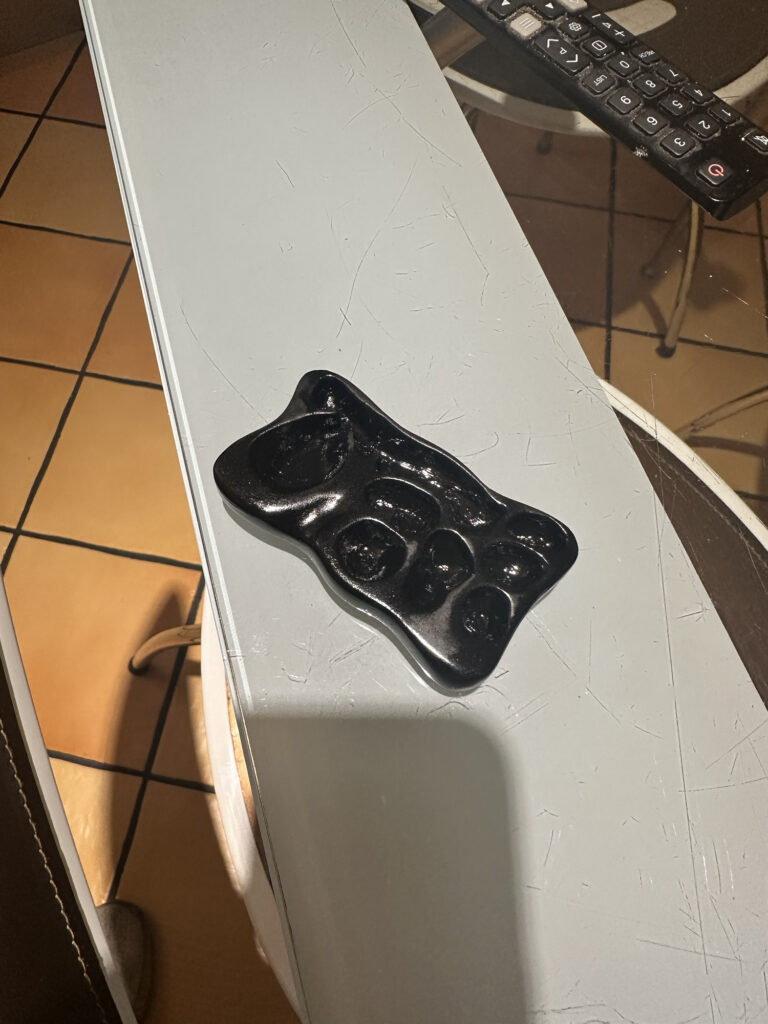 Close-up of a small black costume prop on a worktable