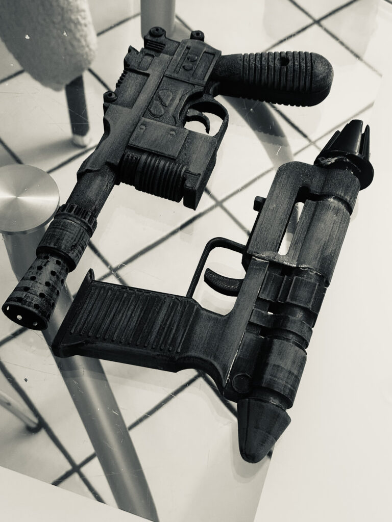 Two black handmade sci-fi blaster props