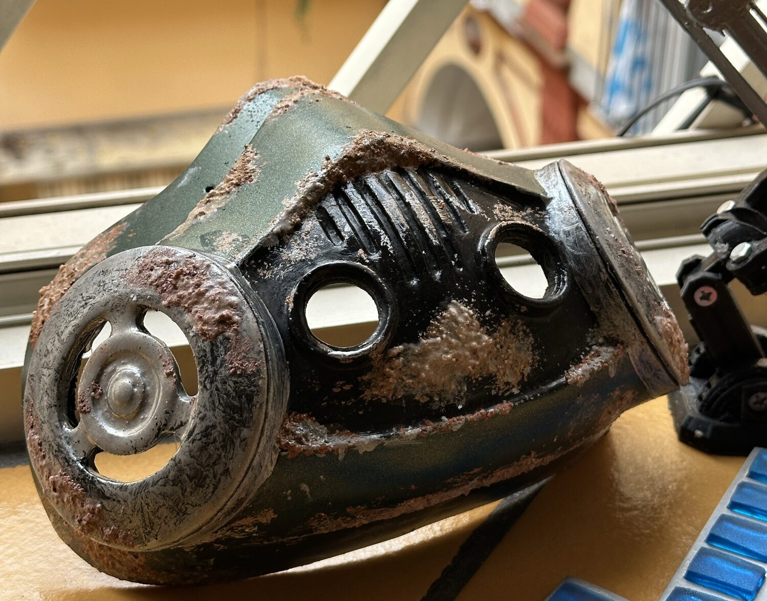Weathered handmade sci-fi respirator mask on a workbench